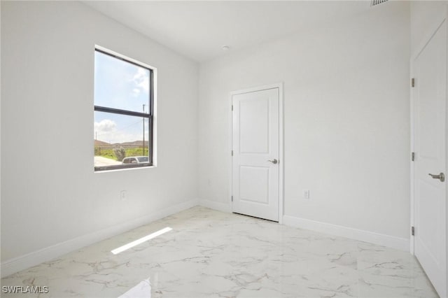 7007 Ramrod Cir, Labelle, FL 33935 - empty room featuring light marble finish floors and baseboards