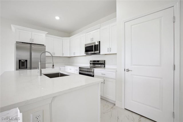 7007 Ramrod Cir, Labelle, FL 33935 - kitchen with appliances with stainless steel finishes, light marble finish flooring, white cabinetry, light countertops, and recessed lighting
