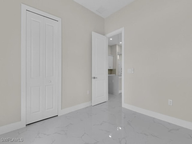 1304 Williams Ave, Lehigh Acres, FL 33972 - unfurnished bedroom featuring light marble finish flooring and a closet