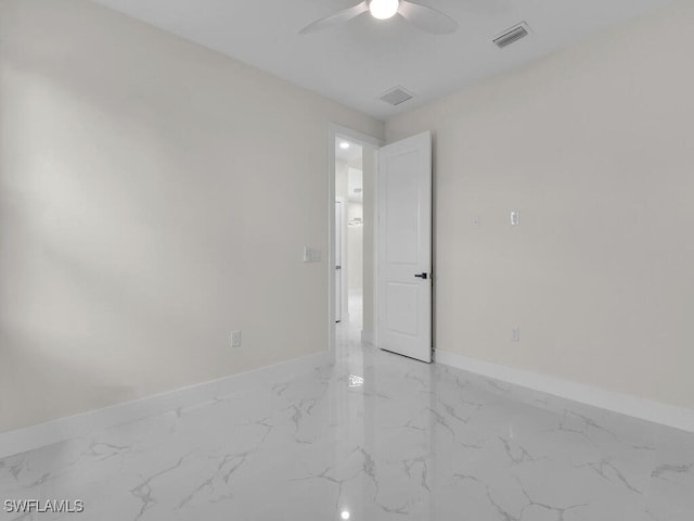 1304 Williams Ave, Lehigh Acres, FL 33972 - spare room featuring light marble finish floors and a ceiling fan