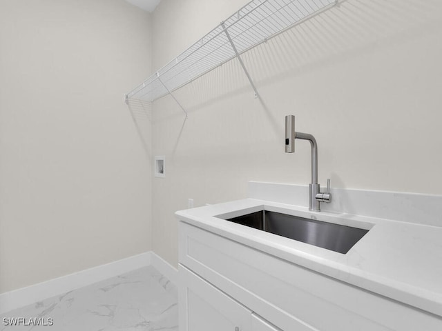 1304 Williams Ave, Lehigh Acres, FL 33972 - laundry area with washer hookup, cabinet space, and marble finish floors