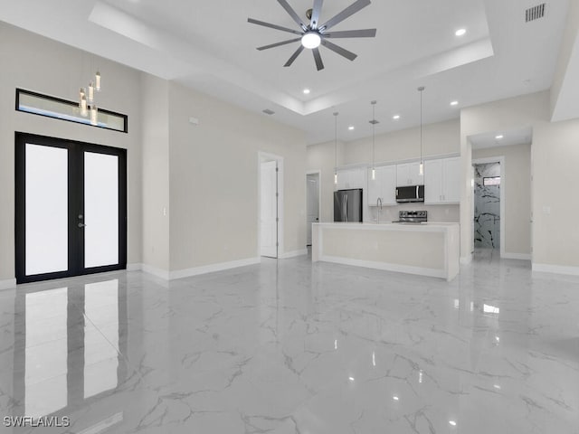 1304 Williams Ave, Lehigh Acres, FL 33972 - unfurnished living room with a raised ceiling, ceiling fan, light marble finish flooring, a towering ceiling, and recessed lighting