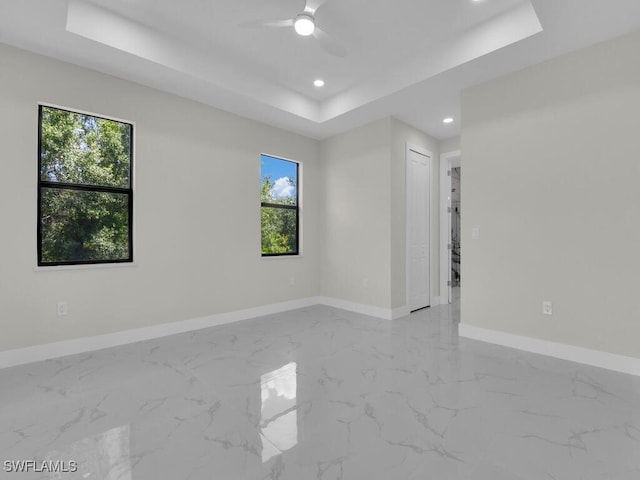 1304 Williams Ave, Lehigh Acres, FL 33972 - empty room with a raised ceiling, recessed lighting, marble finish floors, and ceiling fan