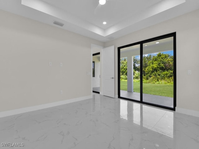 1304 Williams Ave, Lehigh Acres, FL 33972 - spare room featuring a raised ceiling, marble tiled flooring, and recessed lighting