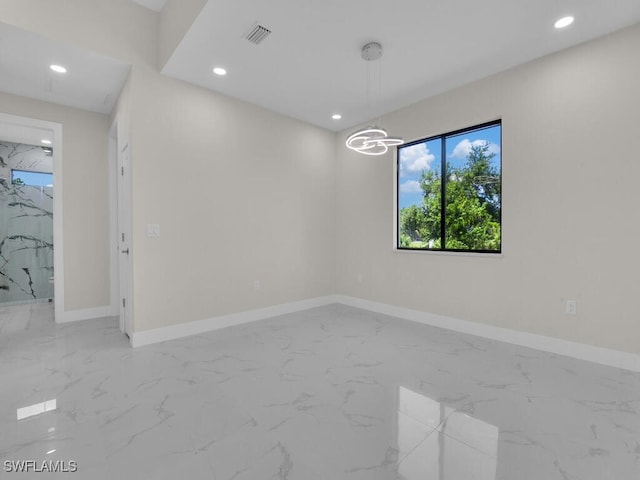 1304 Williams Ave, Lehigh Acres, FL 33972 - spare room featuring marble finish floors, recessed lighting, and a chandelier