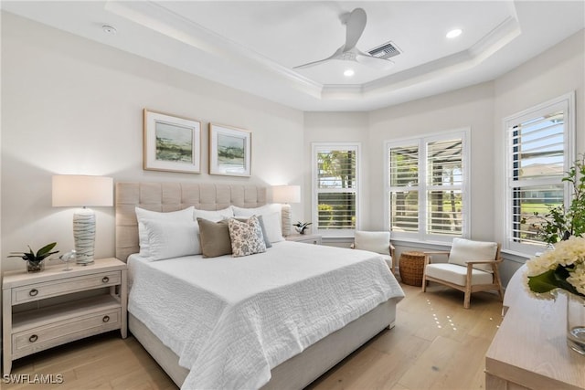 8834 Vaccaro Ct, Naples, FL 34119 - bedroom with a tray ceiling, light wood-style flooring, and recessed lighting