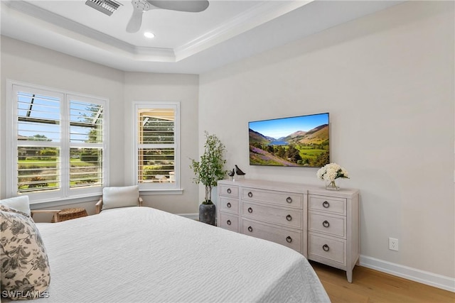 8834 Vaccaro Ct, Naples, FL 34119 - bedroom featuring light wood-style floors, a tray ceiling, a ceiling fan, recessed lighting, and ornamental molding