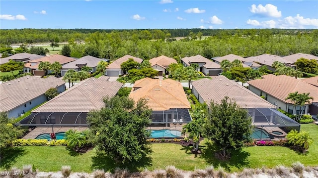 8834 Vaccaro Ct, Naples, FL 34119 - aerial view of residential area featuring a pool and a heavily wooded area