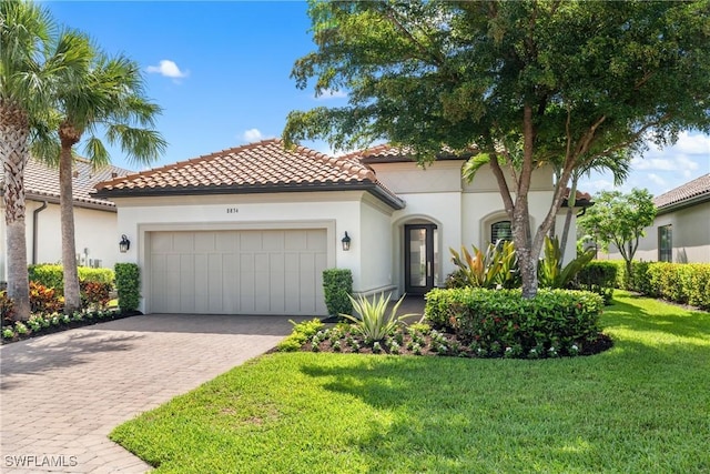 8834 Vaccaro Ct, Naples, FL 34119 - mediterranean / spanish home with a garage, driveway, a front yard, and stucco siding