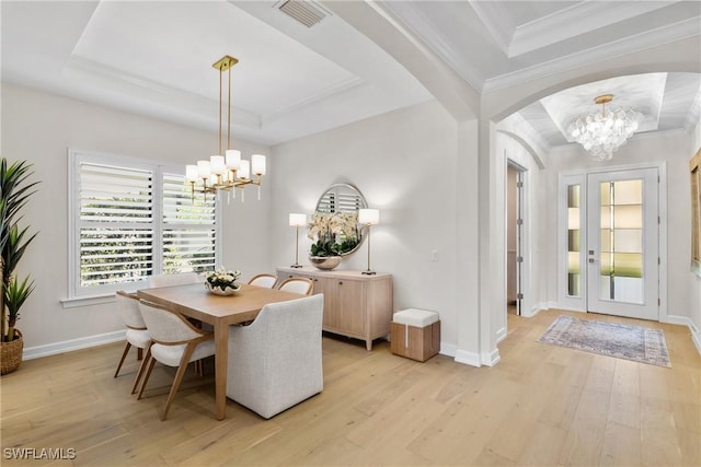 8834 Vaccaro Ct, Naples, FL 34119 - dining area with a chandelier, a tray ceiling, light wood-style flooring, and crown molding