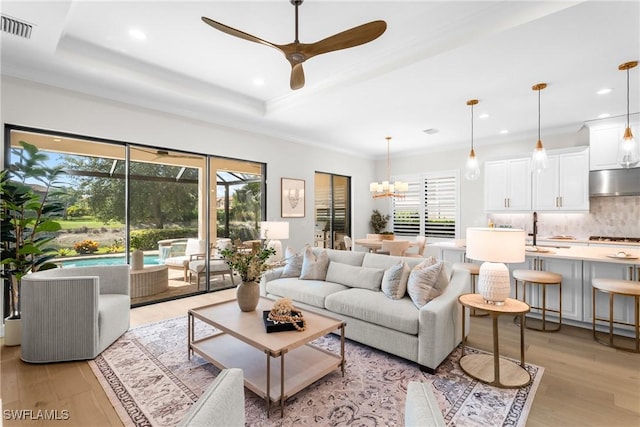 8834 Vaccaro Ct, Naples, FL 34119 - living area featuring plenty of natural light, a ceiling fan, light wood-style floors, recessed lighting, and crown molding