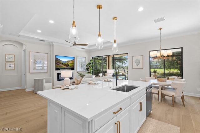 8834 Vaccaro Ct, Naples, FL 34119 - kitchen with light wood-style flooring, open floor plan, recessed lighting, light countertops, and white cabinetry