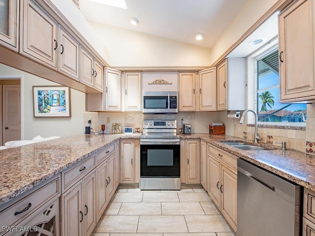 1132 Bond Ct, Marco Island, FL 34145 - kitchen featuring appliances with stainless steel finishes, backsplash, light stone countertops, light tile patterned floors, and light brown cabinetry