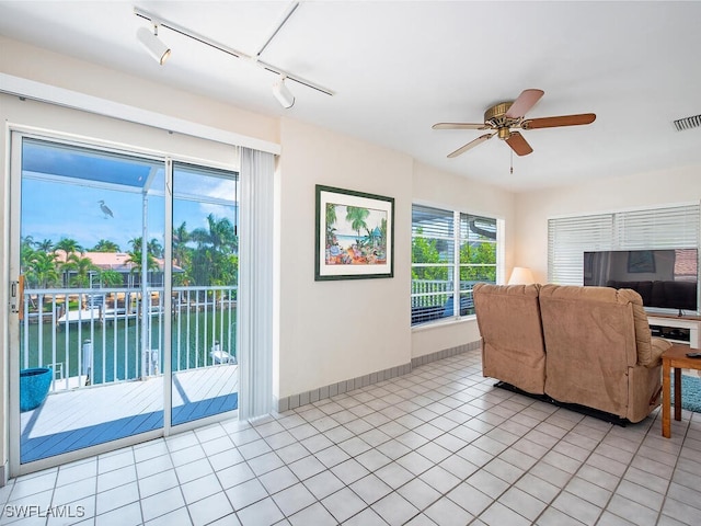 1132 Bond Ct, Marco Island, FL 34145 - living area with track lighting, light tile patterned floors, a ceiling fan, and a water view