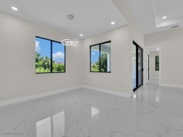 503 Lincoln Blvd, Lehigh Acres, FL 33936 - unfurnished room featuring light marble finish floors, healthy amount of natural light, recessed lighting, and a chandelier