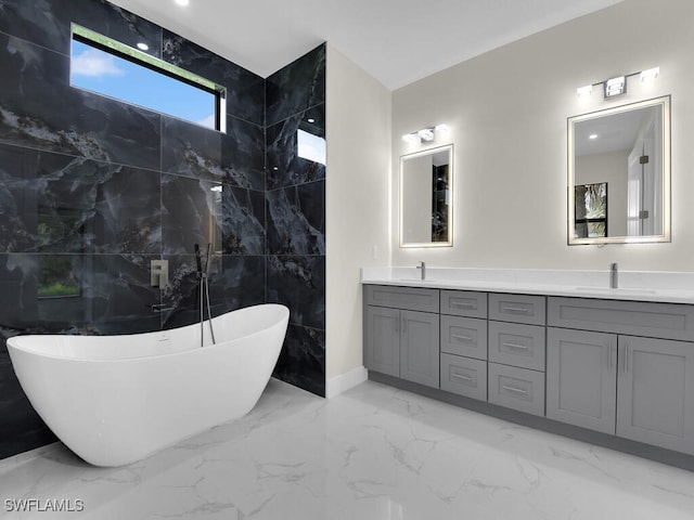 503 Lincoln Blvd, Lehigh Acres, FL 33936 - bathroom with marble tiled flooring, double vanity, and a freestanding tub