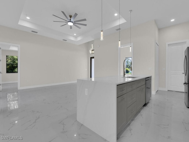 503 Lincoln Blvd, Lehigh Acres, FL 33936 - kitchen featuring gray cabinetry, open floor plan, a tray ceiling, light marble finish flooring, and recessed lighting