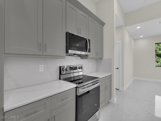 503 Lincoln Blvd, Lehigh Acres, FL 33936 - kitchen featuring appliances with stainless steel finishes, gray cabinetry, light marble finish flooring, light countertops, and recessed lighting