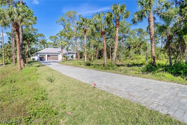 491 9th St SW, Naples, FL 34117 - view of front of property with driveway and a front lawn