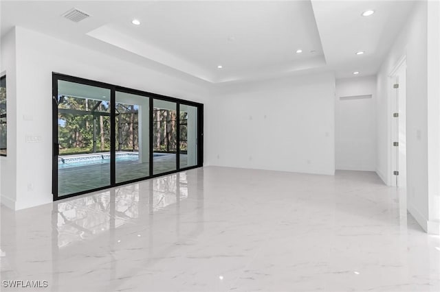 491 9th St SW, Naples, FL 34117 - spare room with a tray ceiling, recessed lighting, and marble finish flooring