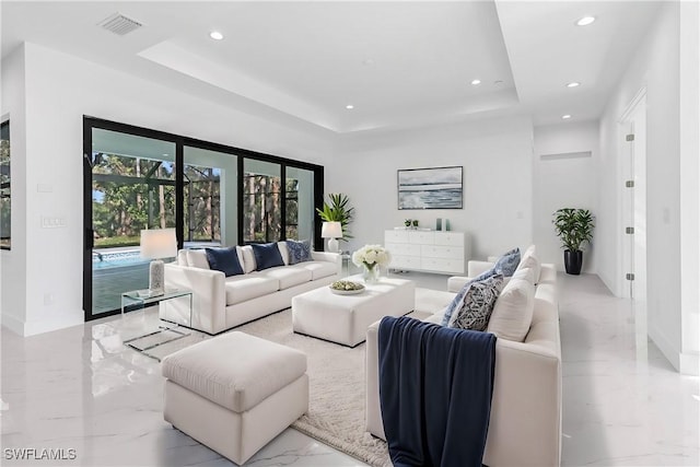 491 9th St SW, Naples, FL 34117 - living room featuring marble tiled floors, a raised ceiling, and recessed lighting