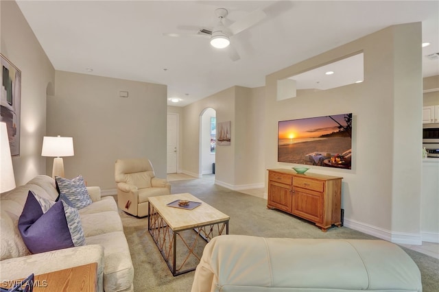 857 Carrick Bend Cir Unit 101, Naples, FL 34110 - living room with arched walkways, a ceiling fan, and light colored carpet