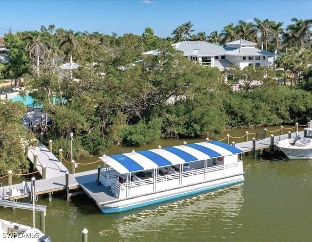 857 Carrick Bend Cir Unit 101, Naples, FL 34110 - dock featuring a water view and view of wooded area
