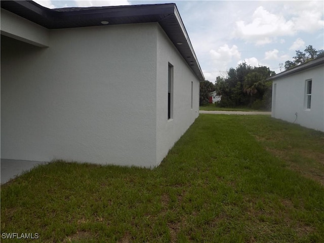 2924 Dunbar Ave, Fort Myers, FL 33916 - view of property exterior featuring stucco siding and a yard