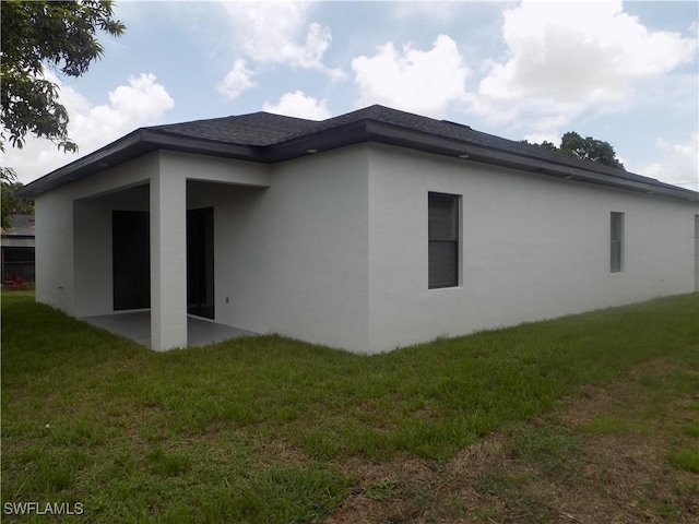2924 Dunbar Ave, Fort Myers, FL 33916 - back of property featuring stucco siding, a yard, and a patio