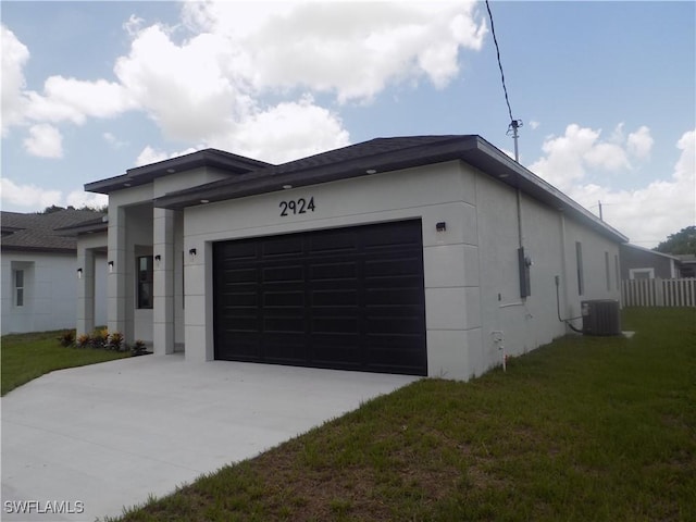 2924 Dunbar Ave, Fort Myers, FL 33916 - view of front of home featuring an attached garage, stucco siding, driveway, and a front yard