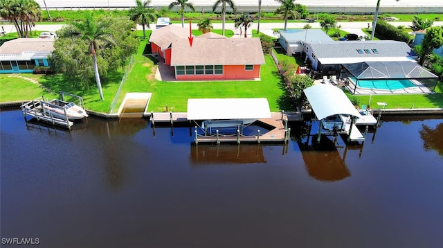 467 Stipe St, North Fort Myers, FL 33903 - dock area with boat lift, a water view, and a lawn