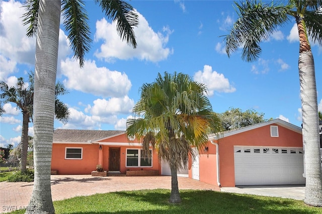 467 Stipe St, North Fort Myers, FL 33903 - ranch-style home featuring decorative driveway, stucco siding, and a garage