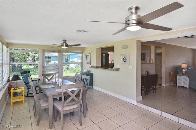 467 Stipe St, North Fort Myers, FL 33903 - dining space featuring a ceiling fan, light tile patterned floors, and a textured ceiling