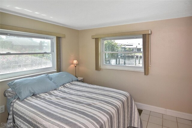 467 Stipe St, North Fort Myers, FL 33903 - bedroom with tile patterned flooring and baseboards