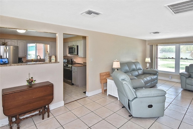 467 Stipe St, North Fort Myers, FL 33903 - living area with light tile patterned flooring and plenty of natural light