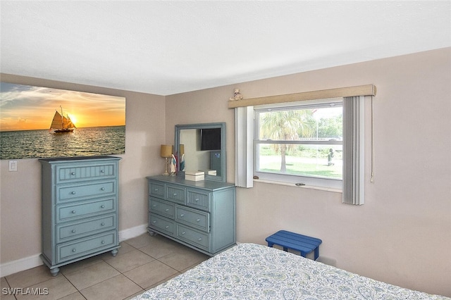 467 Stipe St, North Fort Myers, FL 33903 - bedroom with light tile patterned floors and baseboards