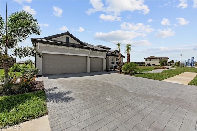524 Burnt Store Rd S, Cape Coral, FL 33993 - ranch-style house with decorative driveway, an attached garage, stucco siding, and a front yard