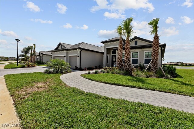 524 Burnt Store Rd S, Cape Coral, FL 33993 - view of front facade with a garage, a front yard, driveway, and stucco siding
