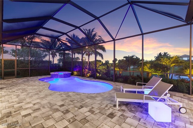 11699 Caleri Ct, Fort Myers, FL 33913 - view of pool featuring a patio area, a pool with connected hot tub, and glass enclosure