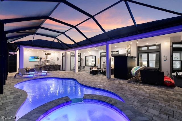 11699 Caleri Ct, Fort Myers, FL 33913 - view of swimming pool with a patio, a pool with connected hot tub, a lanai, outdoor dining space, and an outdoor living space