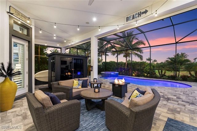 11699 Caleri Ct, Fort Myers, FL 33913 - pool at dusk featuring a patio area, a pool with connected hot tub, an outdoor hangout area, and a lanai