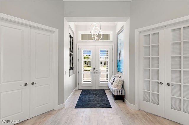 11699 Caleri Ct, Fort Myers, FL 33913 - foyer with french doors, light wood-style floors, and ornamental molding