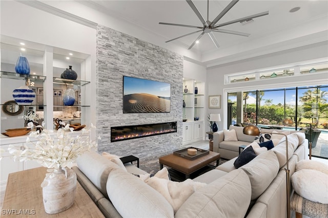 11699 Caleri Ct, Fort Myers, FL 33913 - living area with built in features, a stone fireplace, crown molding, ceiling fan, and recessed lighting