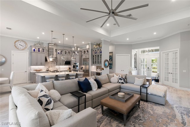 11699 Caleri Ct, Fort Myers, FL 33913 - living room with french doors, light wood-style floors, recessed lighting, a ceiling fan, and ornamental molding