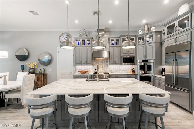11699 Caleri Ct, Fort Myers, FL 33913 - kitchen featuring built in appliances, gray cabinetry, light wood finished floors, crown molding, and recessed lighting