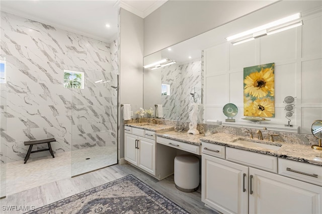 11699 Caleri Ct, Fort Myers, FL 33913 - bathroom with crown molding, a marble finish shower, vanity, wood finished floors, and recessed lighting