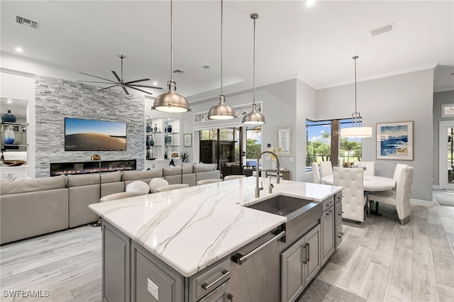 11699 Caleri Ct, Fort Myers, FL 33913 - kitchen with dishwasher, gray cabinets, ceiling fan, ornamental molding, and light wood-style flooring