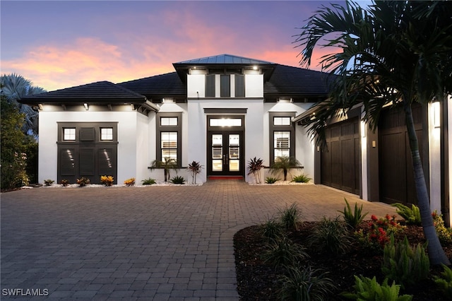 11699 Caleri Ct, Fort Myers, FL 33913 - view of front of property with french doors, decorative driveway, a garage, and stucco siding