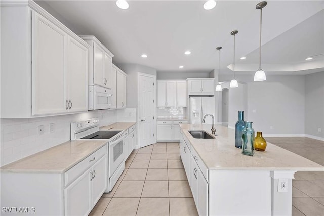 14601 Tropical Dr, Naples, FL 34114 - kitchen featuring white appliances, recessed lighting, light tile patterned floors, and white cabinetry
