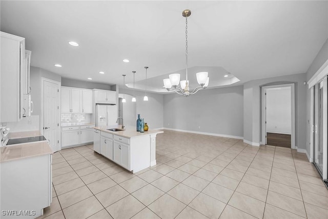 14601 Tropical Dr, Naples, FL 34114 - kitchen with white appliances, light countertops, a chandelier, open floor plan, and backsplash